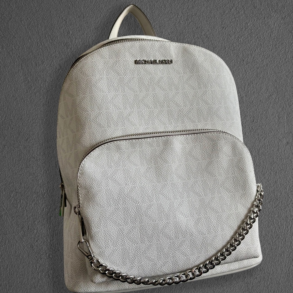 is a Michael Kors monogram backpack